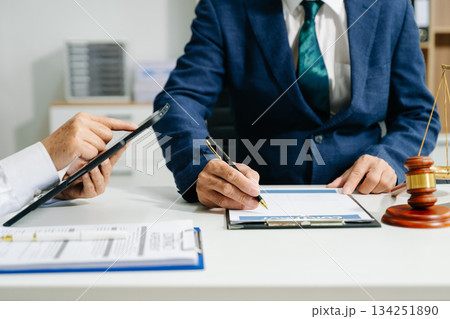 Business and lawyers discussing contract papers with brass scale on desk in office. Law, legal services, advice Business and lawyers discussing contract papers with brass scale on desk in office. Law, legal services, advice 134251890