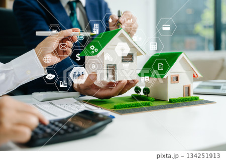 Sustainable architects presenting green building models, solar panels, and recycling symbols. Future clean energy and smart city 134251913