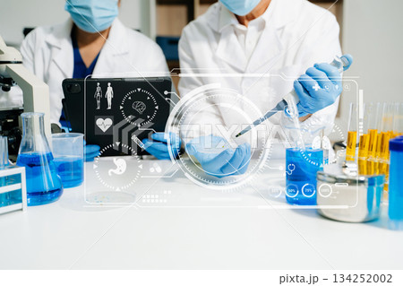 Modern medical research laboratory. female scientist hands working with micro pipettes analyzing biochemical samples 134252002