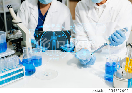 Modern medical research laboratory. female scientist hands working with micro pipettes analyzing biochemical samples 134252003