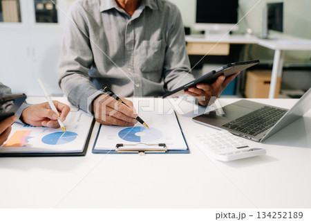 Business documents on office table with smart phone and calculator digital tablet and graph business Business documents on office table with smart phone and calculator digital tablet and graph business 134252189