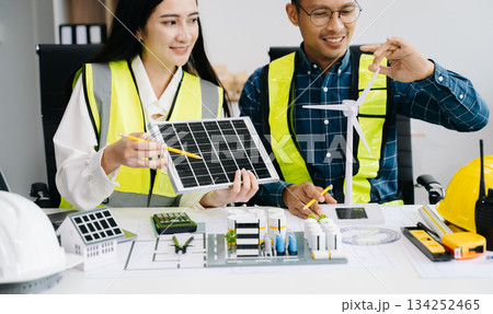 business people having consultation about wind energy at company office. on architectural project site and making model house. business people having consultation about wind energy at company office. on architectural project site and making model house. 134252465