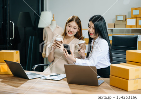 Starting small businesses SME owners, two check online orders Selling products working with boxs freelance work 134253166