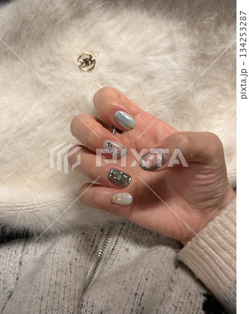 Beautiful nail art with intricate designs and vibrant colors, showcasing glossy finish, smooth texture, and detailed patterns in close-up view 134253287