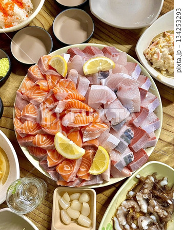 Fresh and delicate sashimi slices, beautifully presented with vibrant colors and perfect cuts. This traditional Japanese delicacy highlights the pure flavors of premium seafood. 134253293