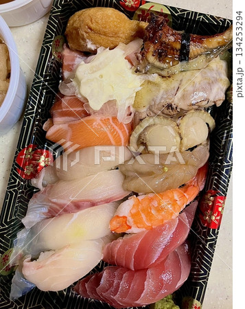 An assortment of fresh sushi, artfully arranged with a variety of toppings and vibrant colors. This traditional Japanese dish combines vinegared rice, seafood, and vegetables for an experience. 134253294