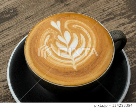 Hot coffee, a hot latte in a mug on a wooden table. Hot coffee, a hot latte in a mug on a wooden table. 134253384
