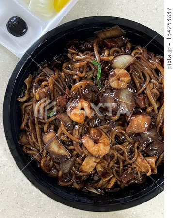 Classic jajangmyeon with thick noodles in a rich black bean sauce, garnished with sliced cucumber and sesame seeds. A beloved Korean-Chinese comfort dish, full of savory depth and flavor. 134253837