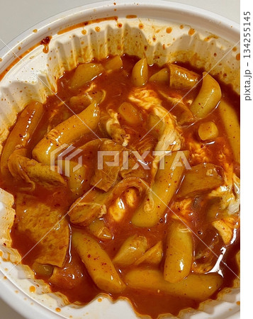 Yeoptteok, a spicy Korean rice cake dish combining chewy tteokbokki with intensely flavored sauce, often paired with fish cakes and boiled eggs. Known for its fiery heat and bold flavors. 134255145