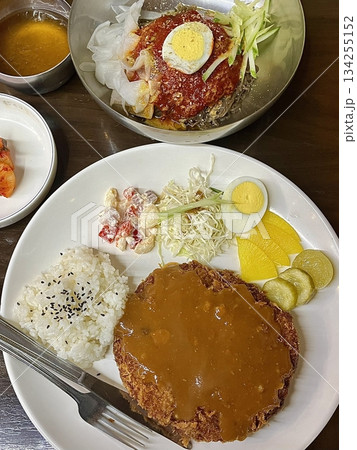 Crispy tonkatsu, a Japanese-style breaded and deep-fried pork cutlet, served with shredded cabbage and drizzled with savory sauce. A delightful balance of crunchy texture and juicy meat. Crispy tonkatsu, a Japanese-style breaded and deep-fried pork cutlet, served with shredded cabbage and drizzled with savory sauce. A delightful balance of crunchy texture and juicy meat. 134255152