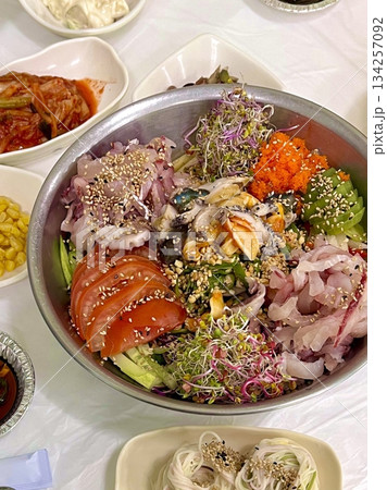 A vibrant poke bowl filled with fresh diced fish, vegetables, and flavorful toppings. Perfect for food photography, this dish embodies the essence of healthy, colorful eating and Hawaiian-inspired. 134257092