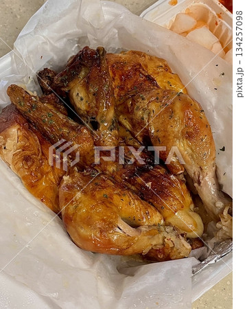 Traditional Korean whole fried chicken with crispy golden skin, served simply to highlight its rustic style, tender meat, and savory flavor reminiscent of classic homemade cooking 134257098