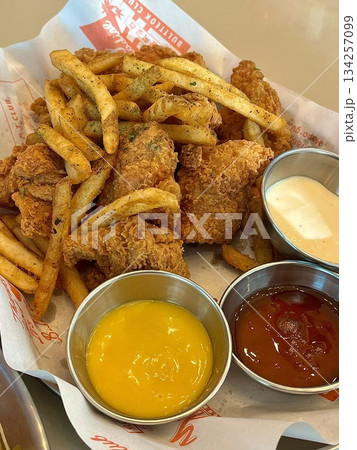 Crispy Korean fried chicken glazed in sweet and spicy sauce, served with golden French fries. A perfect combo of bold flavor and satisfying crunch in every delicious bite. 134257099