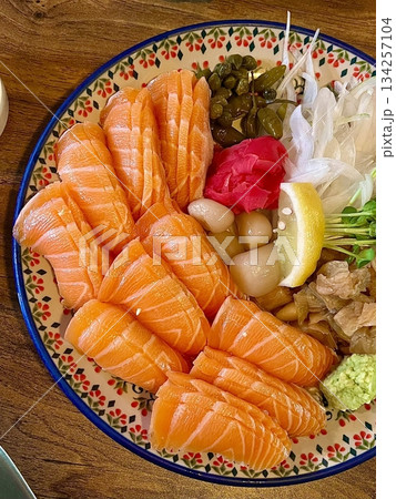 Fresh and delicate sashimi slices, beautifully presented with vibrant colors and perfect cuts. This traditional Japanese delicacy highlights the pure flavors of premium seafood. 134257104