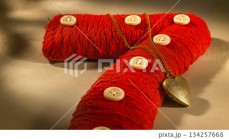 A 3D number 7 wrapped in red yarn and decorated with buttons and a heart medallion. 134257668