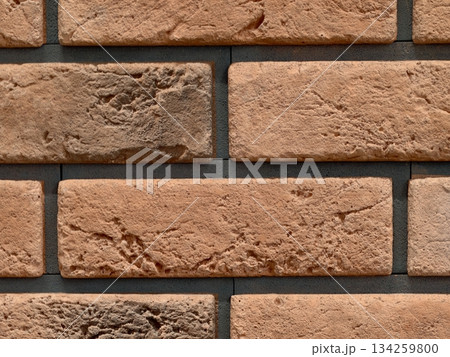 warmtoned urban brick setting, contemporary brick facade featuring warm hues and uniform grout lines warmtoned urban brick setting, contemporary brick facade featuring warm hues and uniform grout lines 134259800