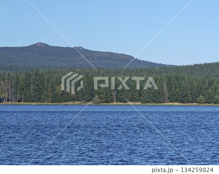 vast outdoor landscape imagery, peaceful lakeside view with mountain outline across wooded area vast outdoor landscape imagery, peaceful lakeside view with mountain outline across wooded area 134259824