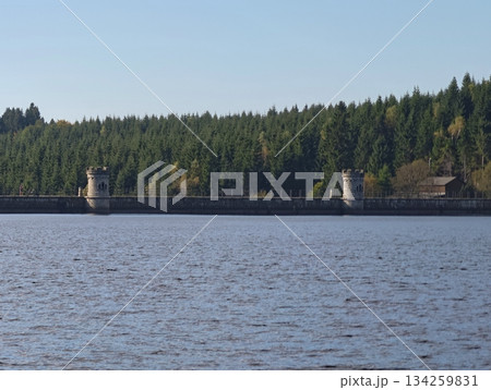 peaceful lake scene, serene water behind mountain structures, tranquil pond with surrounding lush 134259831