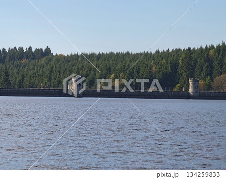 serene energy site, tranquil water basin hosting energygenerating dam structures surrounded by trees serene energy site, tranquil water basin hosting energygenerating dam structures surrounded by trees 134259833
