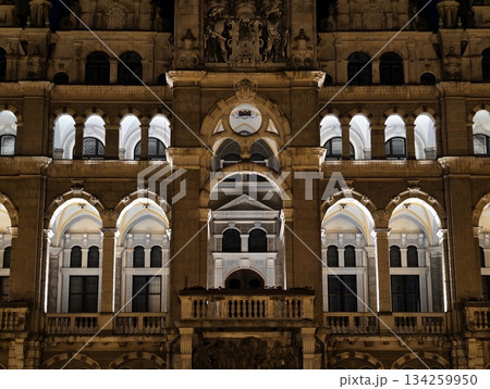 illuminated tower exudes historic grandeur, golden arches and detailed stone carvings shine brightly illuminated tower exudes historic grandeur, golden arches and detailed stone carvings shine brightly 134259950