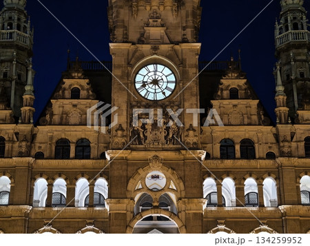 luminous clock sculpture with arches and detailed carvings creates mysterious nighttime ambiance 134259952
