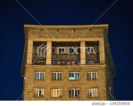 quiet urban building with nostalgic ambiance, serene city block illuminated by cozy yellow lights quiet urban building with nostalgic ambiance, serene city block illuminated by cozy yellow lights 134259958