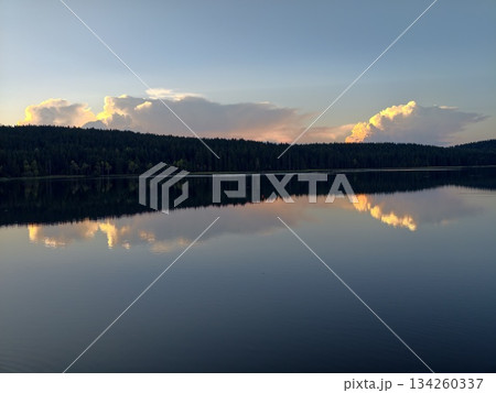 vivid landscape with vibrant sky, cinematic lake view contrasting fiery clouds and tranquil water 134260337