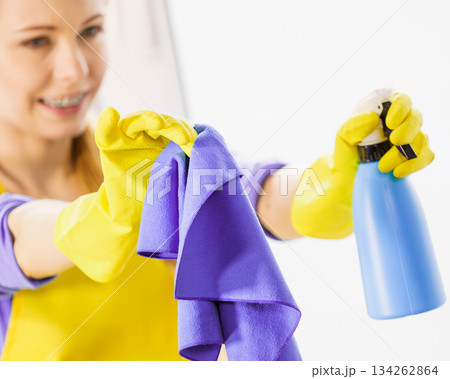 Girl cleaning window at home 134262864