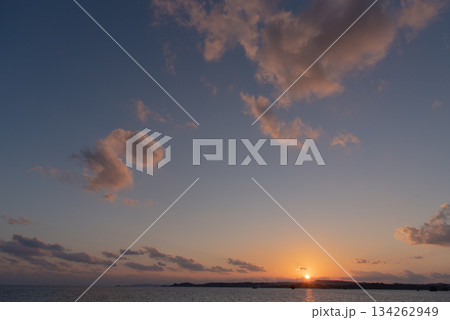 陸地に沈む夕焼けでオレンジ色の太陽 陸地に沈む夕焼けでオレンジ色の太陽 134262949