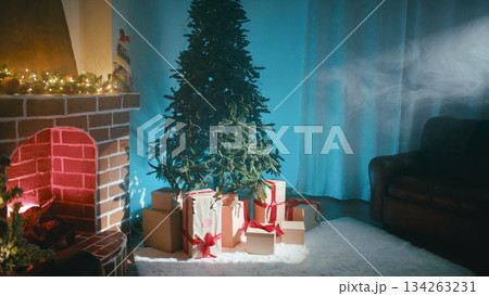 Beam of Light Illuminates Christmas Tree Next to Fireplace Beam of Light Illuminates Christmas Tree Next to Fireplace 134263231