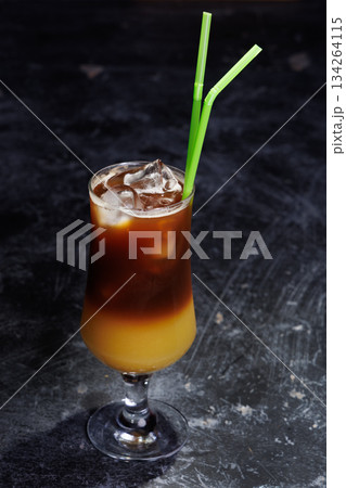Iced Coffee Layered Drink in Glass with Green Straws Iced Coffee Layered Drink in Glass with Green Straws 134264115