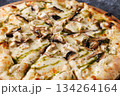 Gourmet Mushroom Cheese Pizza On Circular Wooden Board 134264164