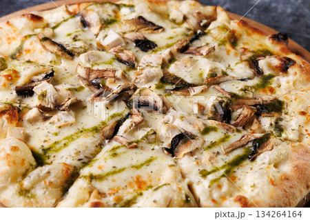 Gourmet Mushroom Cheese Pizza On Circular Wooden Board 134264164