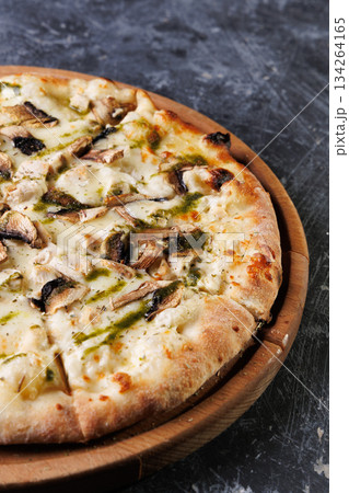 Gourmet Mushroom Cheese Pizza On Circular Wooden Board 134264165