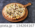 Gourmet Mushroom Cheese Pizza On Circular Wooden Board 134264167