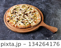 Gourmet Mushroom Cheese Pizza On Circular Wooden Board 134264176