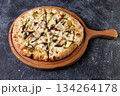 Gourmet Mushroom Cheese Pizza On Circular Wooden Board 134264178