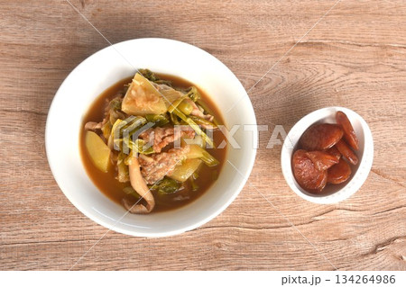 spicy boiled tilapia fish with mixed vegetable in curry soup Thai food in bowl and fried sweet Chinese sausage spicy boiled tilapia fish with mixed vegetable in curry soup Thai food in bowl and fried sweet Chinese sausage 134264986