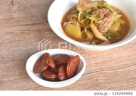 spicy boiled tilapia fish with mixed vegetable in curry soup Thai food in bowl and fried sweet Chinese sausage  134264988