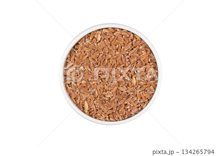 A bowl of brown grains with a white background A bowl of brown grains with a white background 134265794