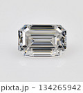 A white emerald cut diamond is sitting on a white background 134265942