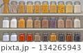 A shelf full of glass jars containing various spices and grains 134265943