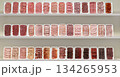 A row of meat products are displayed on a shelf 134265953