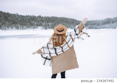 Beautiful woman posing in winter forest. Great winter weather and atmosphere. Christmas. Beautiful woman posing in winter forest. Great winter weather and atmosphere. Christmas. 134267492