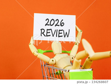 2026 Review symbol. Concept words 2026 Review on beautiful white card. Beautiful orange paper background. Businessman's model. Business and 2026 review concept. Copy space. 134268607