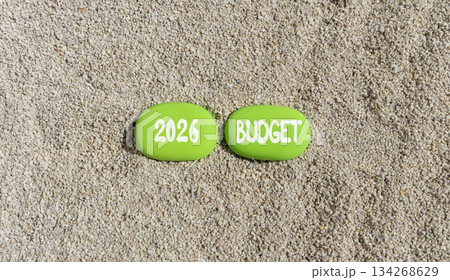 2026 Budget symbol. Concept words 2026 Budget on beautiful green stones on sand beach. Beautiful sand beach background. Business and 2026 budget concept. Copy space. 134268629