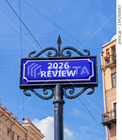 2026 Review symbol. Concept words 2026 Review on beautiful blue road sign. Beautiful blue sky and buildings background. Business and 2026 review concept. Copy space. 134268667