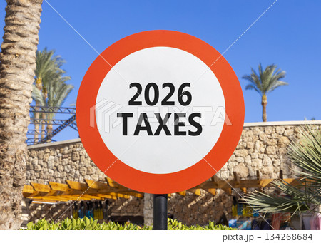 2026 taxes new year symbol. Concept words 2026 taxes on beautiful white and red road sign. Beautiful palm trees palm-trees and blue sky background. Business and 2026 taxes new year concept. Copy space 134268684