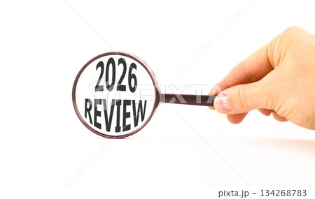 2026 Review symbol. Concept words 2026 Review on beautiful white paper. Black magnifying glass. Businessman's hand. Beautiful white paper background. Business and 2026 review concept. Copy space. 2026 Review symbol. Concept words 2026 Review on beautiful white paper. Black magnifying glass. Businessman's hand. Beautiful white paper background. Business and 2026 review concept. Copy space. 134268783