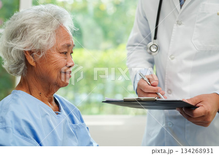 Doctor taking care, help and encourage Asian elder senior woman patient in clinic hospital. Doctor taking care, help and encourage Asian elder senior woman patient in clinic hospital. 134268931